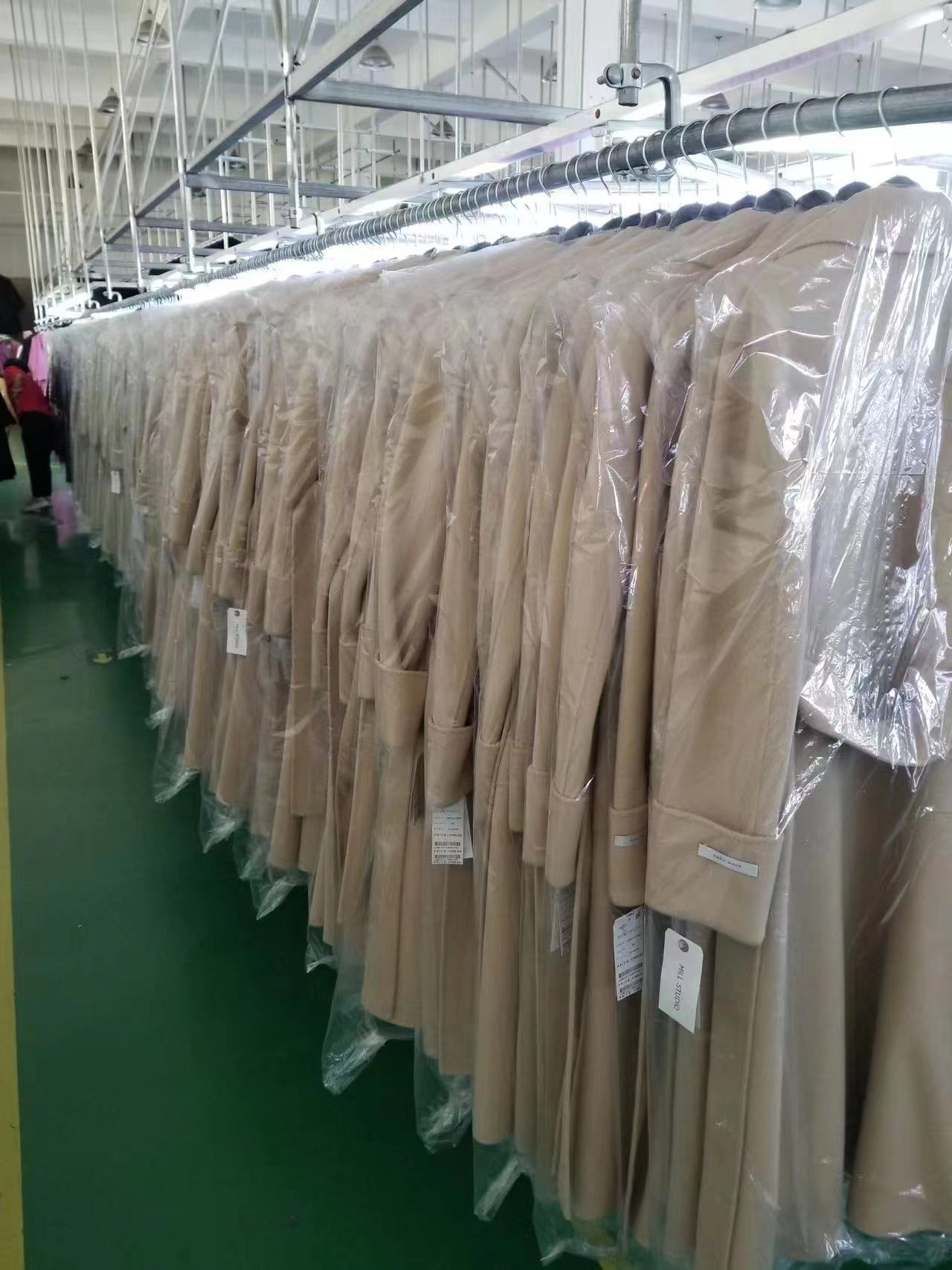 Finished outerwear on rails in protective covers