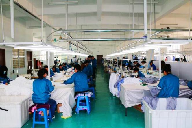 Workers completing hand sewing at the factory