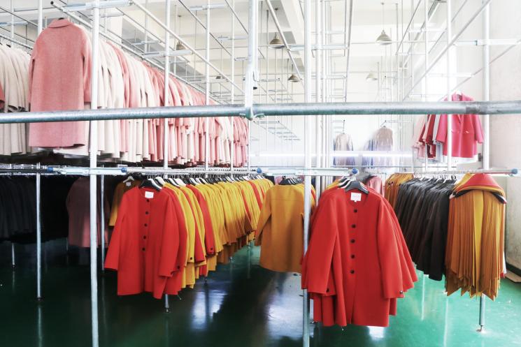 A selection of wool coats on garment rails in the factory